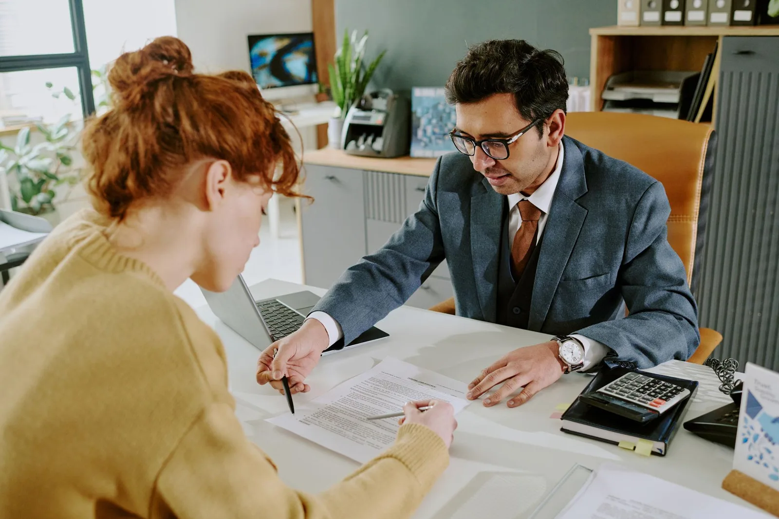 Two people shaking hands during a financial discussion